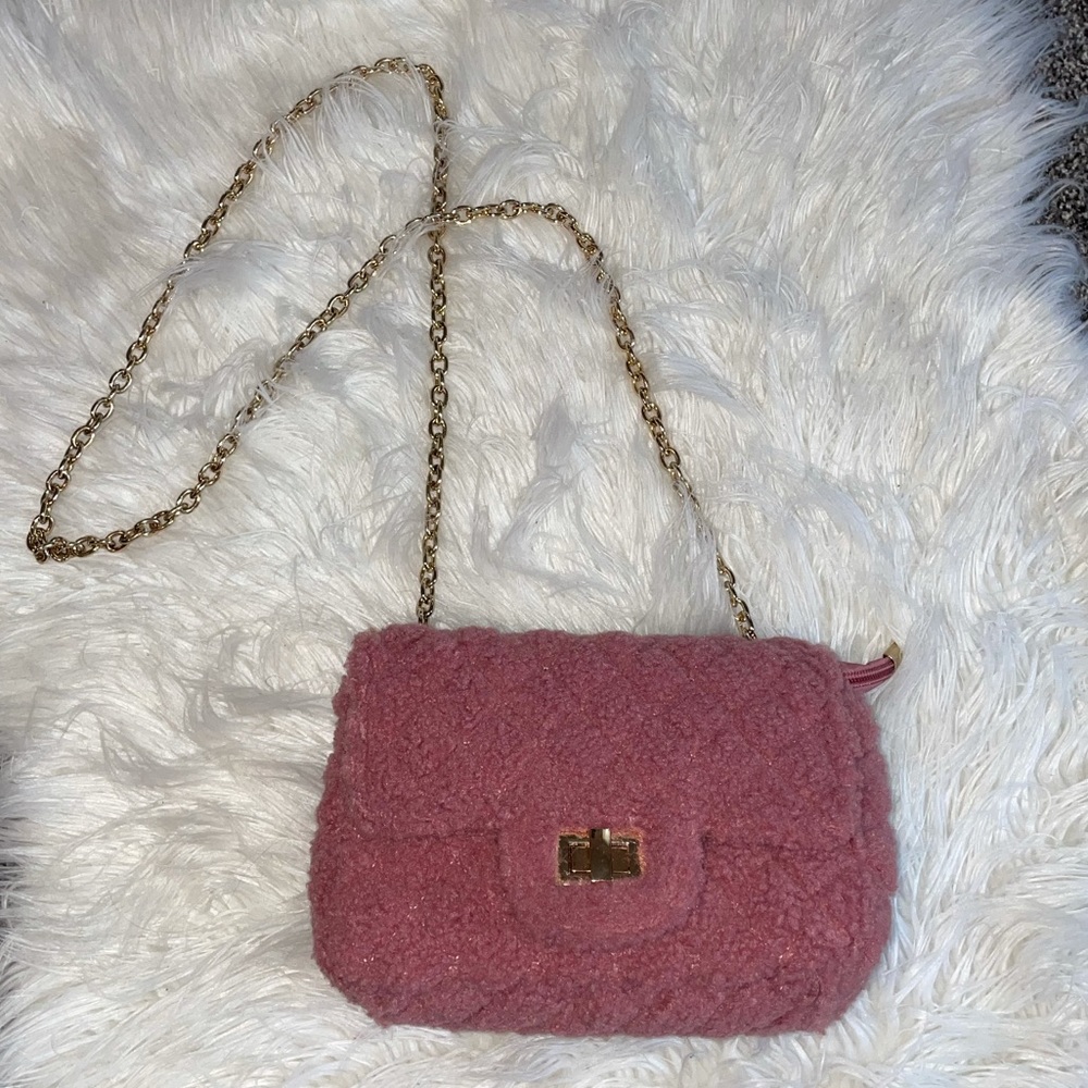 NWOT muave colored fuzzy purse with gold chain.